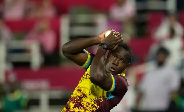West Indies bowler Rovman Powell takes a catch to dismiss South Africa's batsman Quinton de Kock during the T20 International cricket match between South Africa and West Indies, in Johannesburg, South Africa, Saturday, Jan. 31, 2026. (AP Photo/Themba Hadebe)