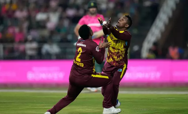 West Indies bowler Akeal Hosein, right, takes a catch to dismiss South Africa's batsman Aiden Markram during the T20 International cricket match between South Africa and West Indies, in Johannesburg, South Africa, Saturday, Jan. 31, 2026. (AP Photo/Themba Hadebe)