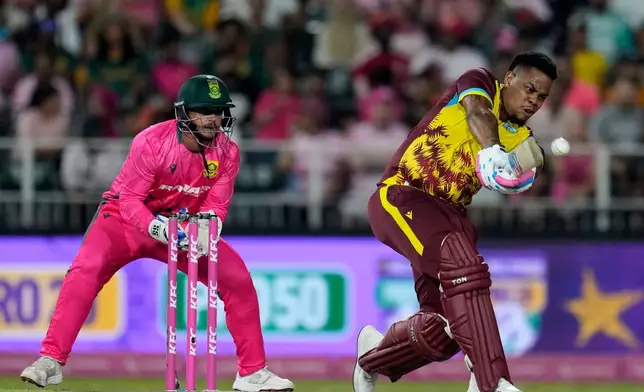 West Indies batsman Shimron Hetmyer, right, plays a shot as South Africa's wicketkeeper Quinton de Kock watches on during the T20 International cricket match between South Africa and West Indies, in Johannesburg, South Africa, Saturday, Jan. 31, 2026. (AP Photo/Themba Hadebe)