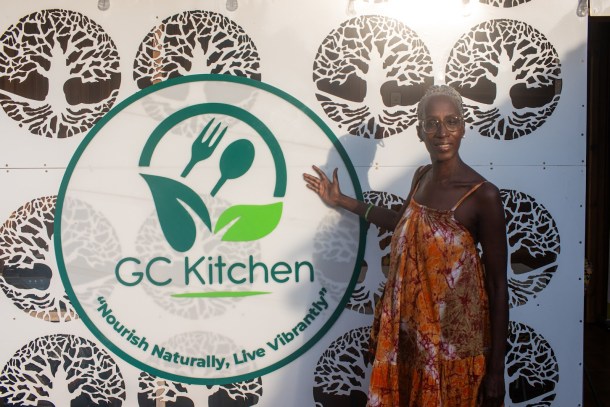 Metcher-Aa Ukhut, a former resident of Washington D.C., at the entrance to Gut-Care, a restaurant she and other expatriates frequent in Accra, Ghana. Ukhut has lived in Accra for three years. Louis Bryant III OBSERVER