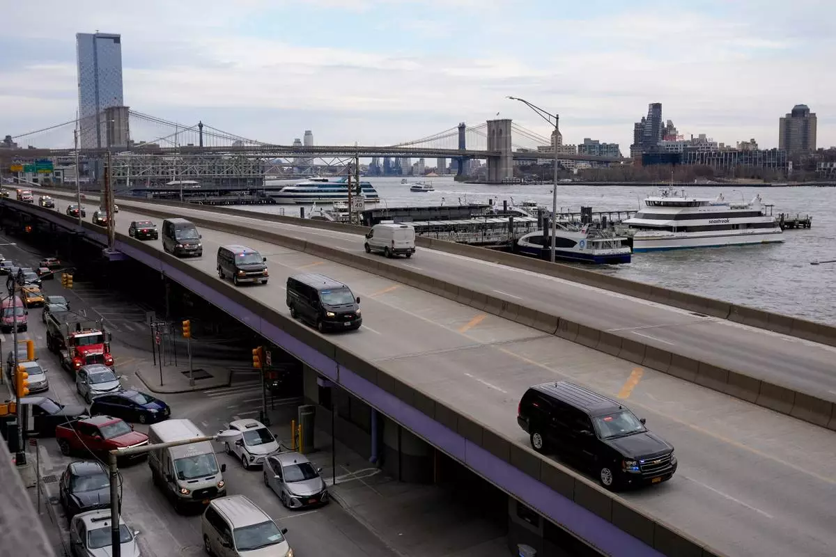 A motorcade makes its way down the FDR Drive after leaving Manhattan Federal Court where Venezuelan President Nicolas Maduro was arraigned with his wife Cilia Flores, Monday, Jan. 5, 2026, in New York. (AP Photo/Seth Wenig)
