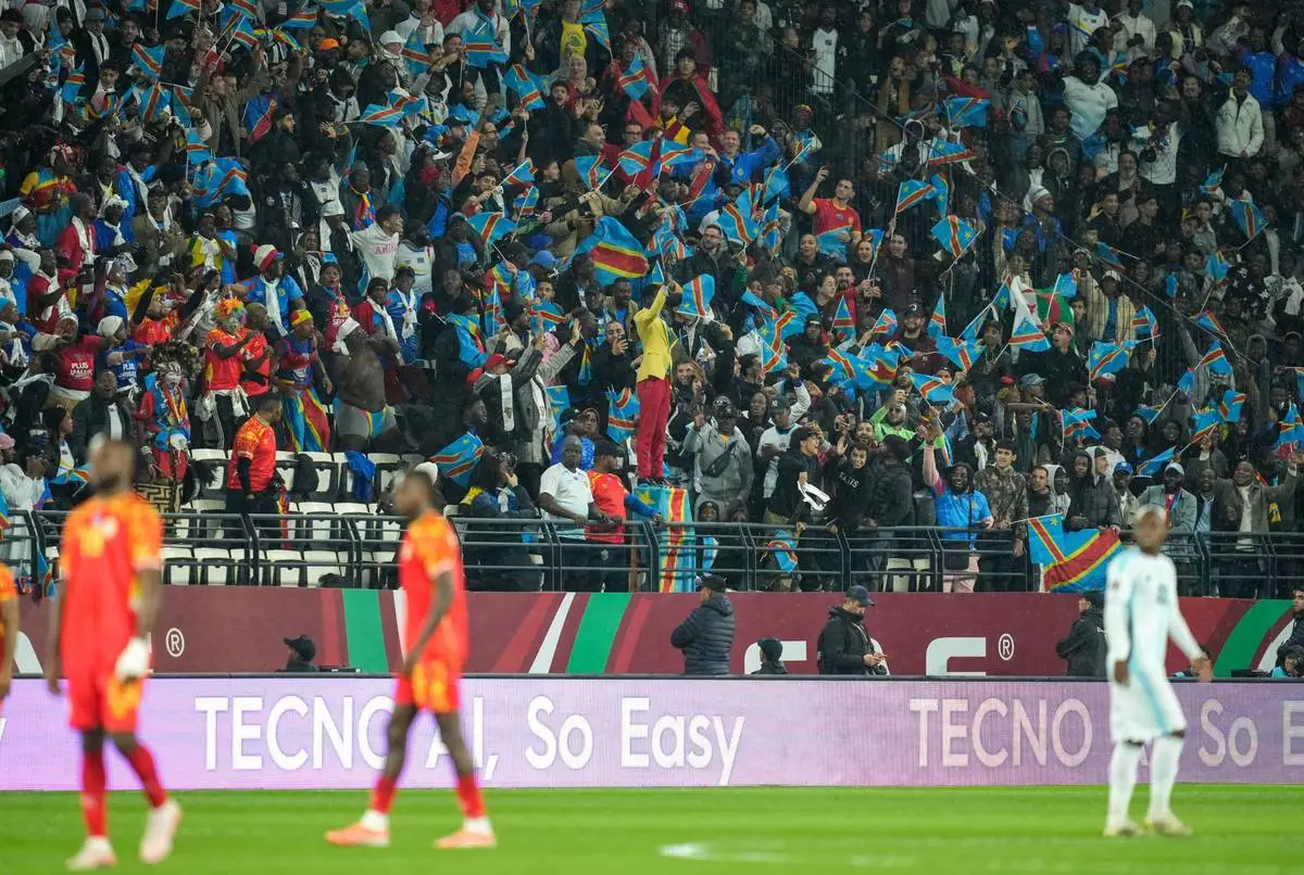 Michel Nkuka Mboladinga, a DR Congo fan impersonating late Congolese leader Patrice Lumumba, strikes a pose during the Africa Cup of Nations group D soccer match between Botswana and DR Congo in Rabat, Morocco, Tuesday, Dec. 30, 2025. (AP Photo/Mosa'ab Elshamy)