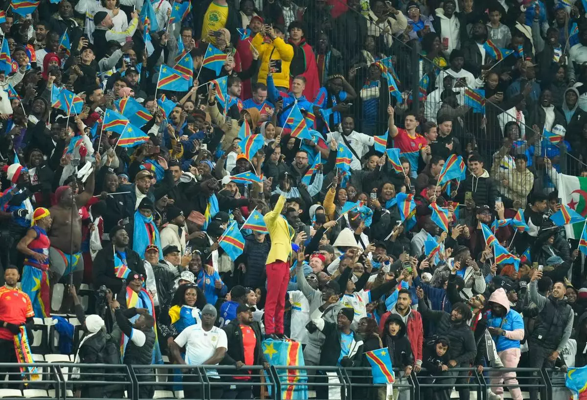 Michel Nkuka Mboladinga, a DR Congo fan impersonating late Congolese leader Patrice Lumumba, strikes a pose during the Africa Cup of Nations group D soccer match between Botswana and DR Congo in Rabat, Morocco, Tuesday, Dec. 30, 2025. (AP Photo/Mosa'ab Elshamy)