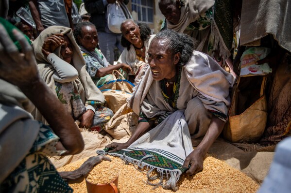 An Ethiopian woman argues with others over the allocation of yellow split peas after it was distributed by the Relief Society of Tigray in the town of Agula, in the Tigray region of northern Ethiopia, May 8, 2021. (AP Photo/Ben Curtis, File)