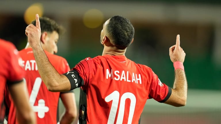 Egypt's Mohamed Salah celebrates after scoring his side's third goal...