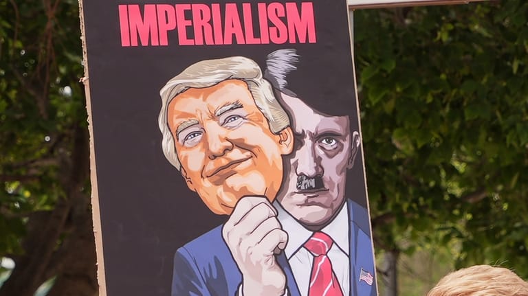 People demonstrate outside the U.S. Embassy in Pretoria, South Africa,...