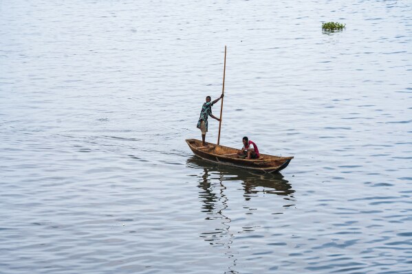 Residents on a boat on the Lagos Lagoon on Saturday, Dec. 6, 2025. (AP Photo/Grace Ekpu)