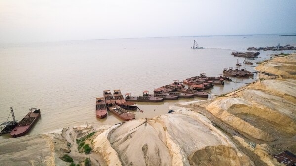Aerial view of heaps of sand and dredging equipment in the busy Ajah area of Lagos, Nigeria, on Saturday, Dec. 6, 2025. Lagos is in constant construction. Roads, bridges and housing estates are rising daily on reclaimed waterfronts as the city's rich displace many of its poor. (AP Photo/Grace Ekpu)