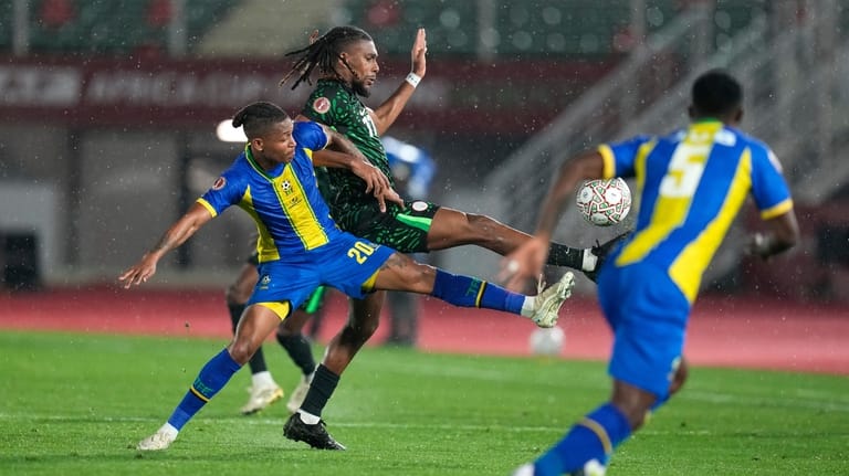 Nigeria's Alex Iwobi is challenged by Tanzania's Novatus Miroshi during...