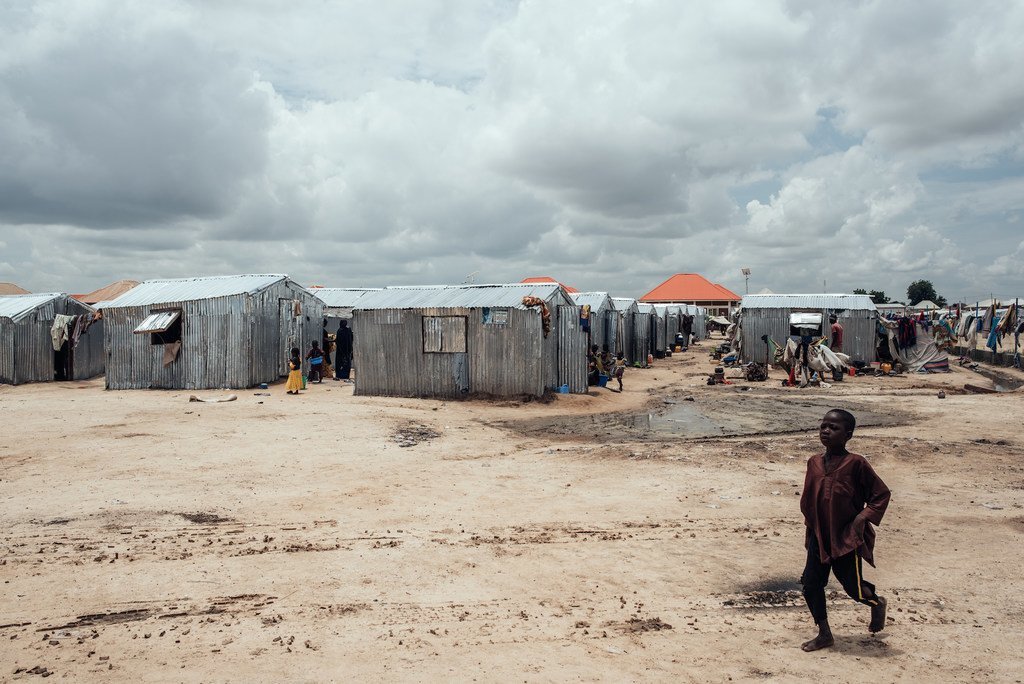 Un enfant marche devant des abris dans un camp de déplacés à Maiduguri, la capitale de l'État de Borno, dans le nord-est du Nigeria.