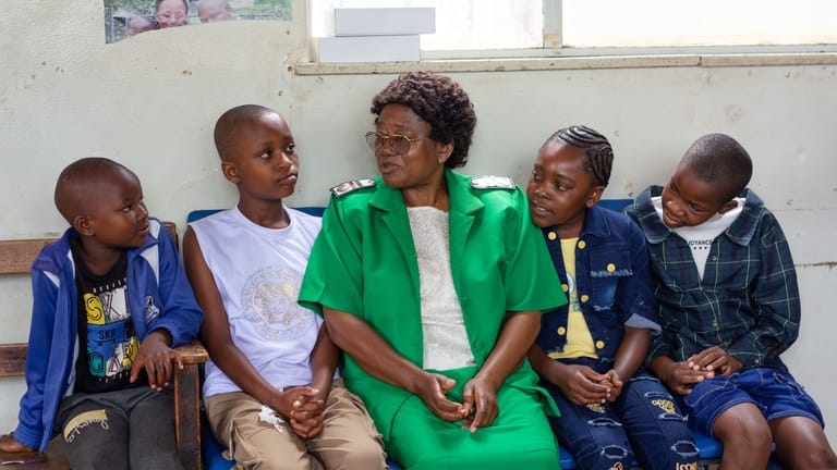 A nurse talks to young girls before they received free...