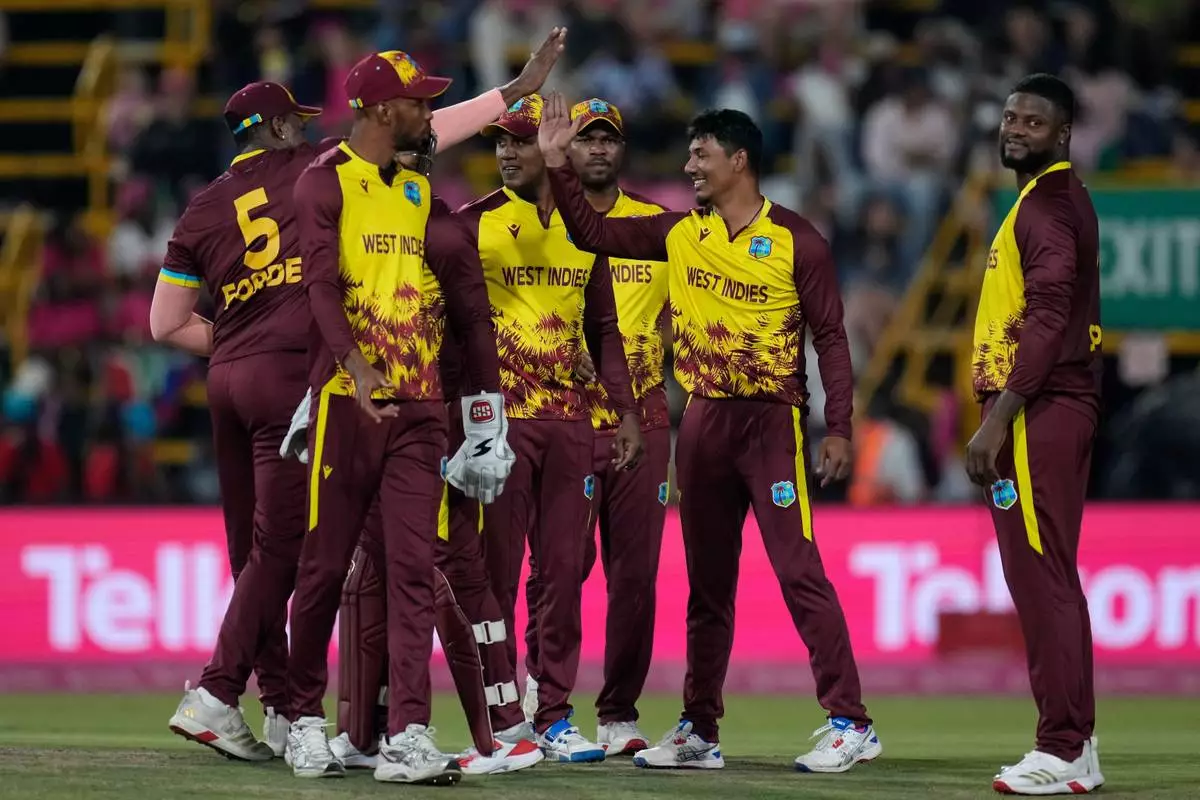 West Indies bowler Gudakesh Motie, second from right, celebrates with his teammates after taking a wicket during the T20 International cricket match between South Africa and West Indies, in Johannesburg, South Africa, Saturday, Jan. 31, 2026. (AP Photo/Themba Hadebe)