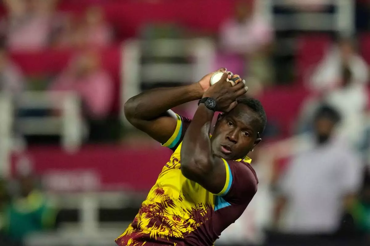 West Indies bowler Rovman Powell takes a catch to dismiss South Africa's batsman Quinton de Kock during the T20 International cricket match between South Africa and West Indies, in Johannesburg, South Africa, Saturday, Jan. 31, 2026. (AP Photo/Themba Hadebe)