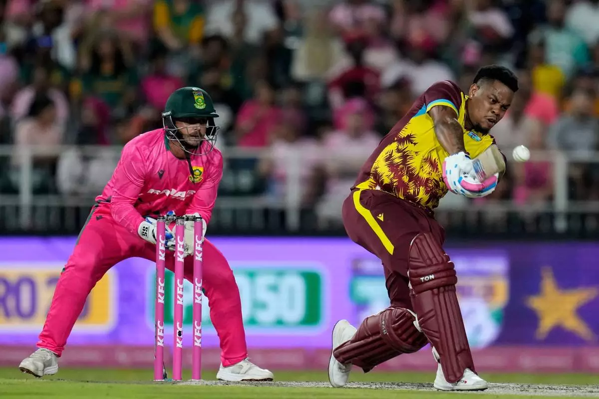 West Indies batsman Shimron Hetmyer, right, plays a shot as South Africa's wicketkeeper Quinton de Kock watches on during the T20 International cricket match between South Africa and West Indies, in Johannesburg, South Africa, Saturday, Jan. 31, 2026. (AP Photo/Themba Hadebe)
