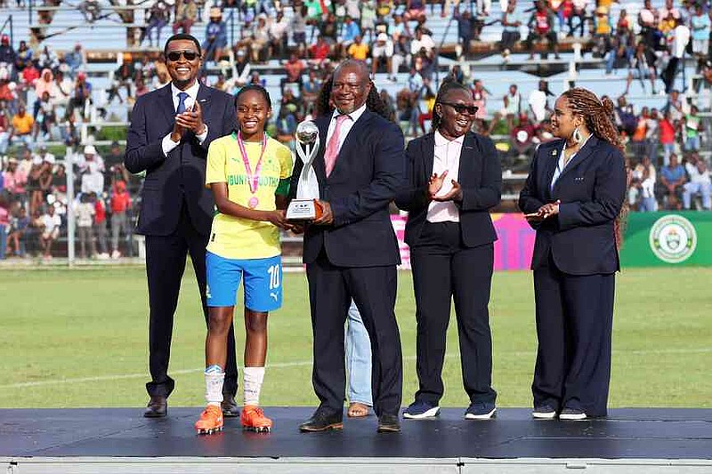 The winning team poses with the trophy after the Under-17 girls tournament promoted by Africa's governing body to promote the cervical cancer vaccination in Norton, Zimbabwe, Thursday, Dec. 18, 2025. (AP Photo/Aaron Ufumeli)