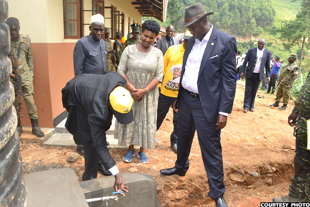 Rtd. Col Bright Rwamirama inspects the 10000-litre water tank donated to Bizenga Primary School.