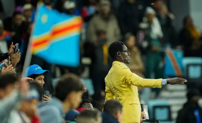 Michel Nkuka Mboladinga, a DR Congo fan impersonating late Congolese leader Patrice Lumumba, strikes a pose during the Africa Cup of Nations group D soccer match between Botswana and DR Congo in Rabat, Morocco, Tuesday, Dec. 30, 2025. (AP Photo/Mosa'ab Elshamy)