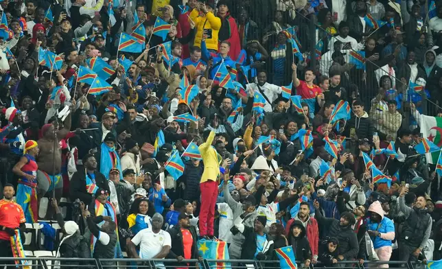 Michel Nkuka Mboladinga, a DR Congo fan impersonating late Congolese leader Patrice Lumumba, strikes a pose during the Africa Cup of Nations group D soccer match between Botswana and DR Congo in Rabat, Morocco, Tuesday, Dec. 30, 2025. (AP Photo/Mosa'ab Elshamy)