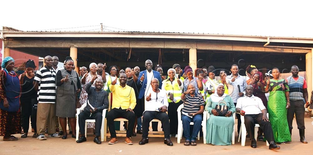 Ian Gumisiriza (in yellow) with he SACCOS' executive and some of the members. (Credit: Jeff Andrew Lule)