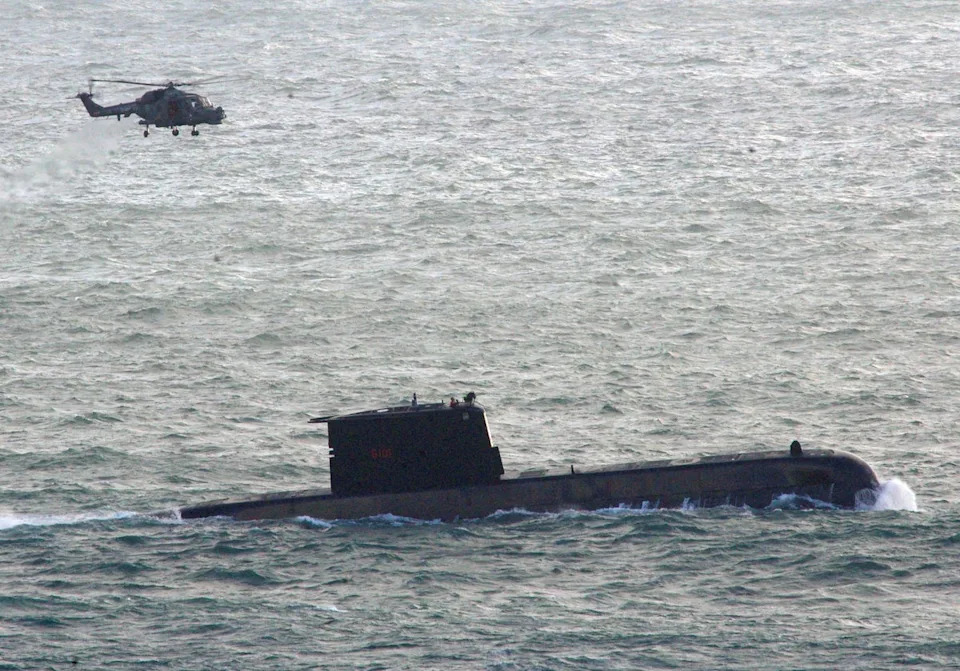 A helicopter flys over a South Africa Navy submarine, following an incident with a South Africa Navy submarine during exercises off Kommetjie in Cape Town, South Africa September 20, 2023 (Reuters)