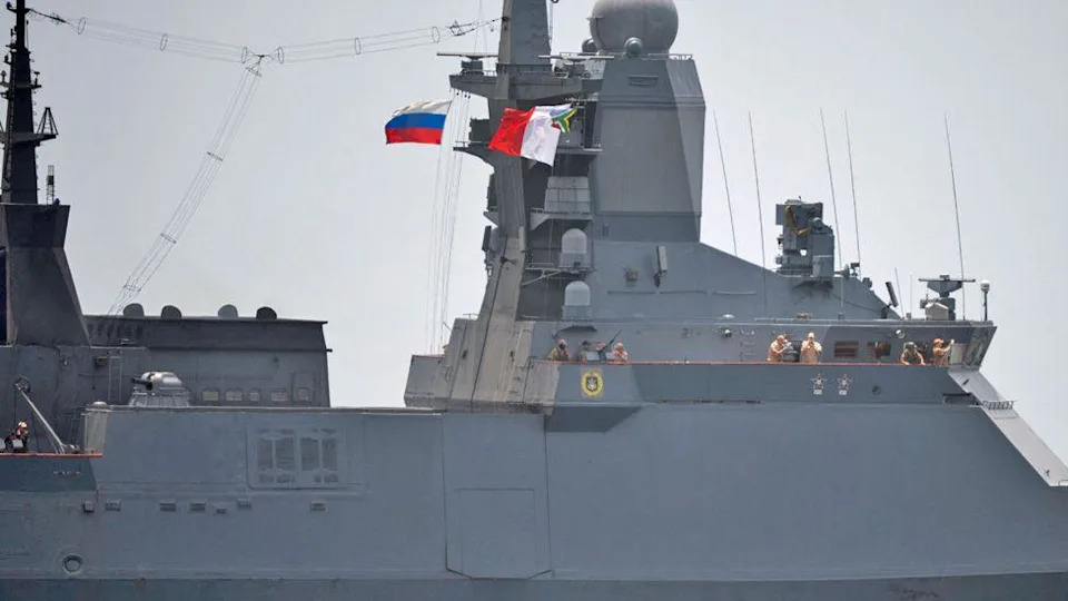 A close-up of a Russian warship - some officers can been seen looking at the view as they come into the harbour.