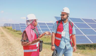 Two young delegates from Africa visit a photovoltaic power generation park in the Talatan Gobi Desert, Northwest China