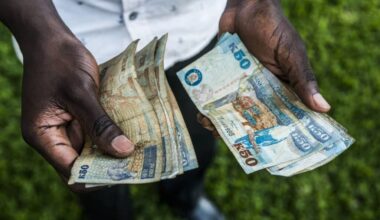 A man counts out Zambian kwacha