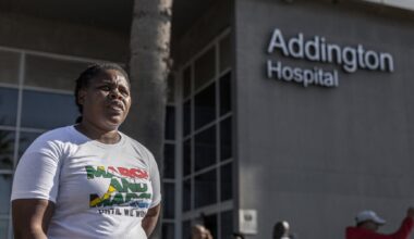 An activist of "March and March", an anti-immigration vigilante group, stands outside the Addington Hospital in Durban on July 4, 2025, during a demonstration in which members were checking for the nationality of those seeking to access the facility. The group worked to deny access to the hospital for anyone they didn't consider South African. (Photo by RAJESH JANTILAL/AFP via Getty Images)