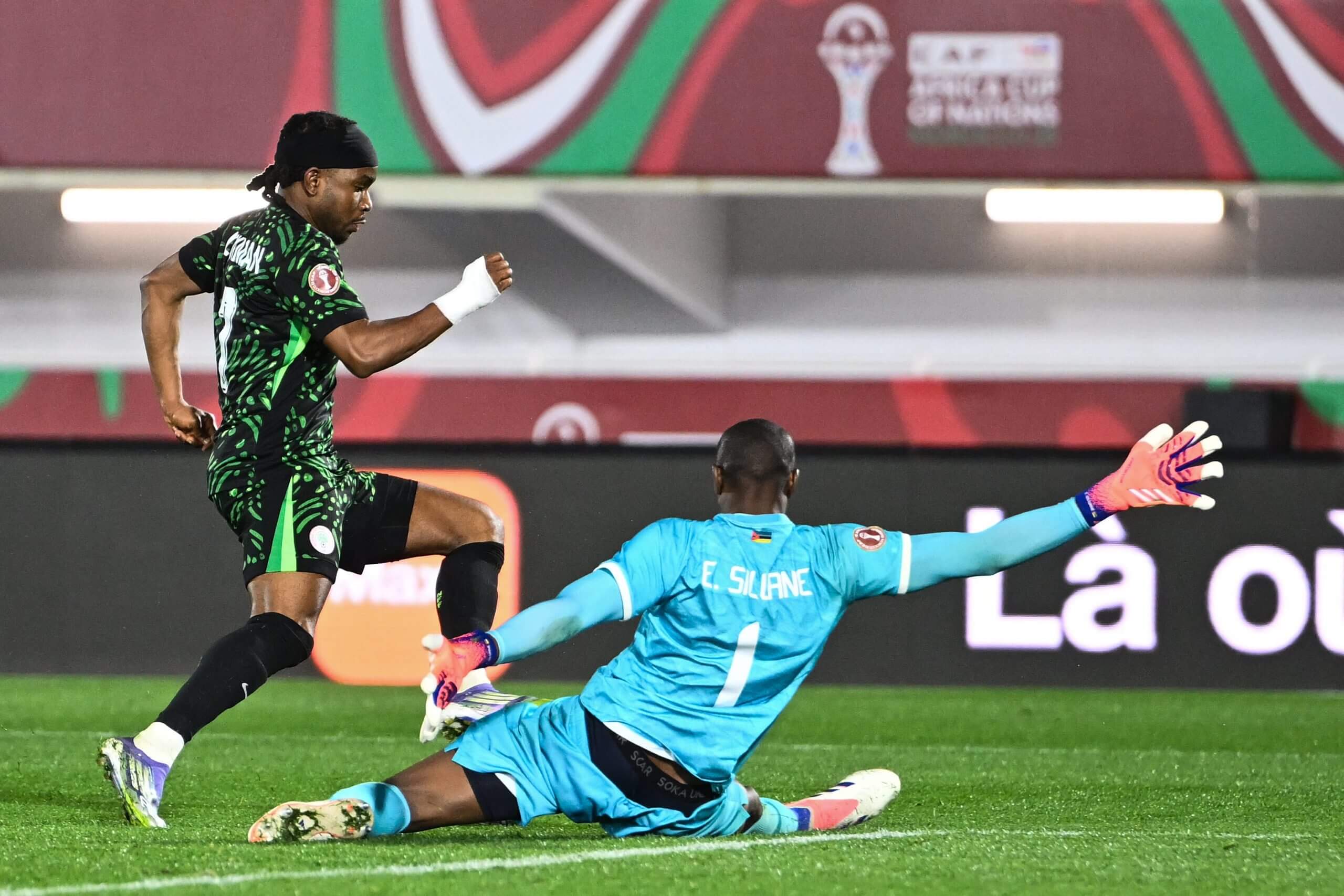 Ademola Lookman is challenged by Mozambique's goalkeeper