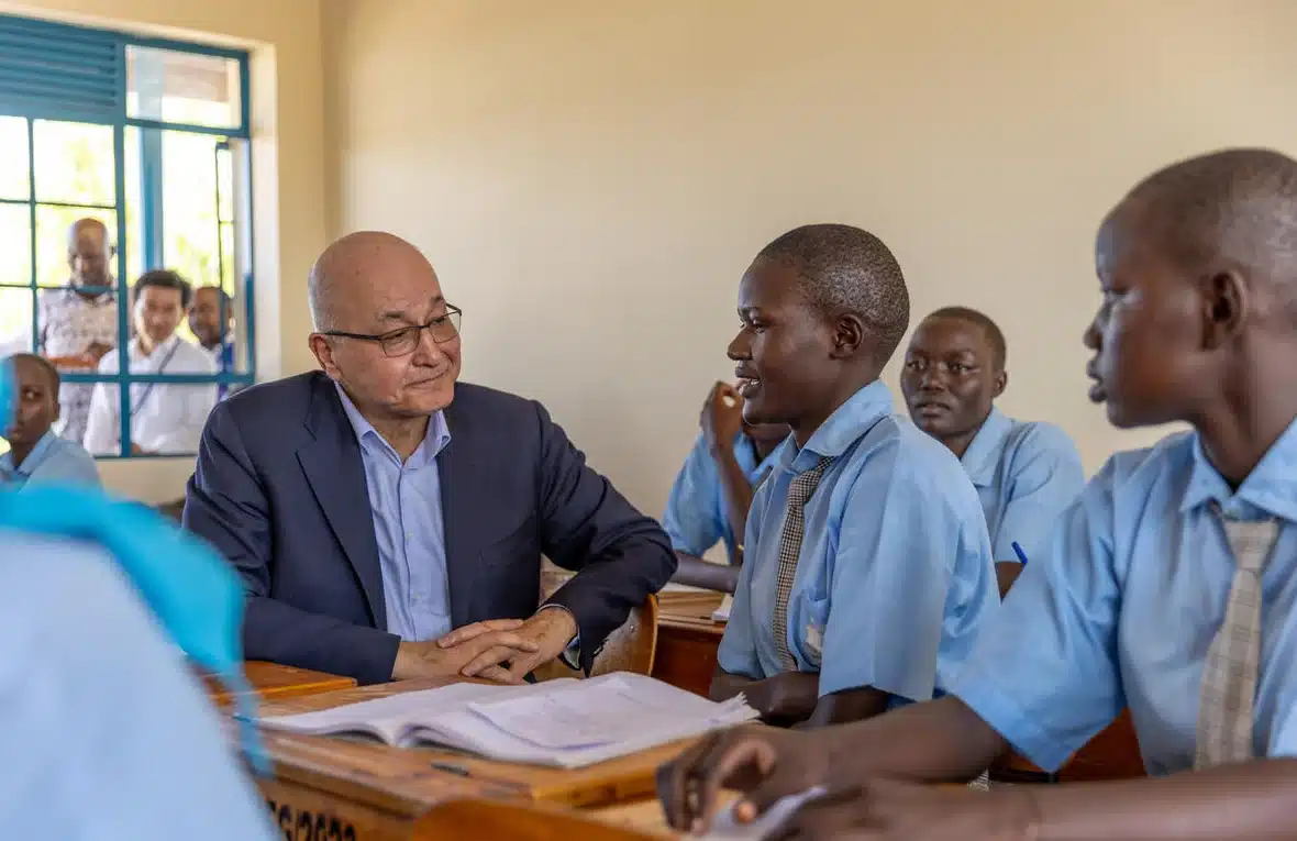 UN High Commissioner for Refugees Barham Salih speaks with female students sitting in a classroom at The Big Heart Foundation Secondary School in Kakuma, Kenya.