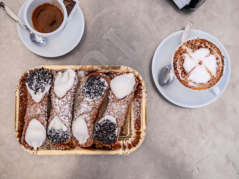 Plate of Sicilian cannoli and coffee served up for participants of the Porsche Travel Experience Sicily