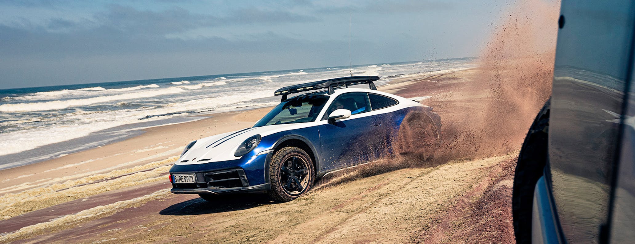 Porsche 911 Dakar driving on Swakopmund beach in Namibia
