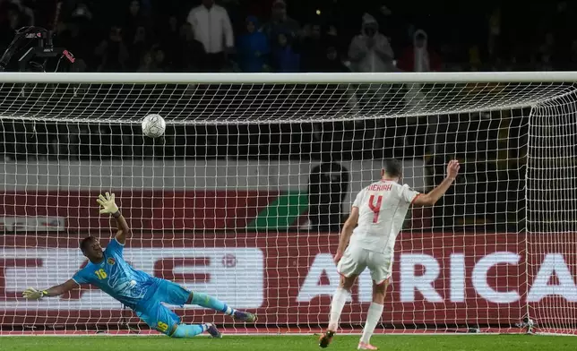 Tunisia's Yassine Meriah, right, scores a penalty kick against Mali's goalkeeper Djigui Diarra during the Africa Cup of Nations best of 16 soccer match between Mali and Tunisia in Casablanca, Morocco, Saturday, Jan. 3, 2026. (AP Photo/Themba Hadebe)