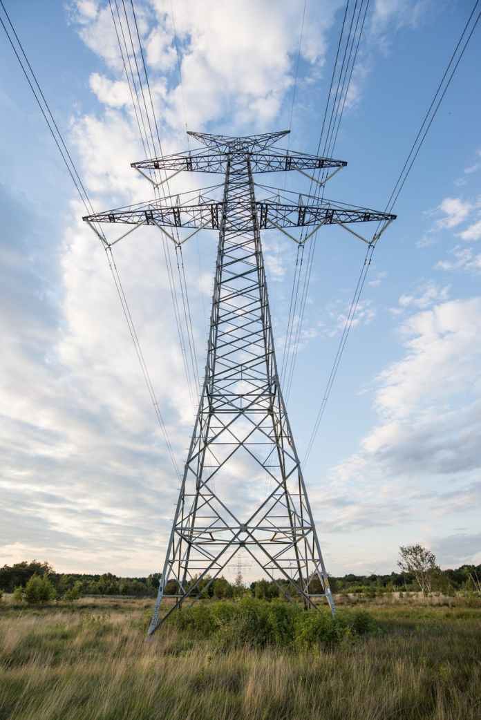low angle photo of gray transmission tower