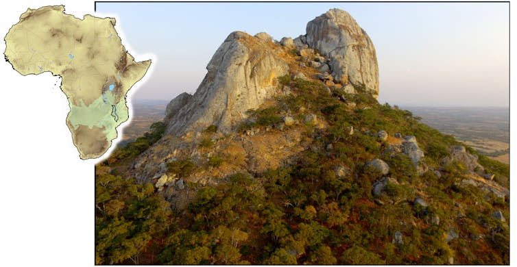 Small map of Africa next to a big image of a bare rock mountaintop at sunset. The slopes are covered in forest.