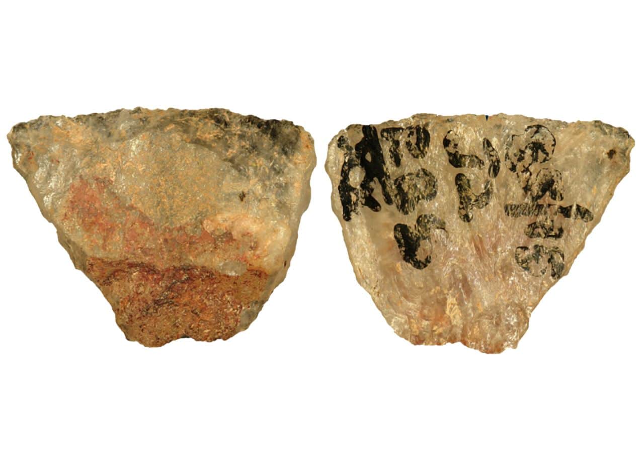 Microlith 001 showing the reddish poisonous adhesive residue still adhering to the dorsal backed portion of the tool