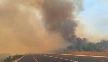 Homes threatened as strong winds hamper firefighting crews