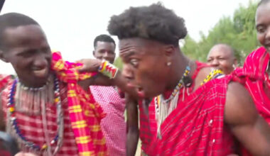 IShowSpeed sits on stage, holding microphone at event.