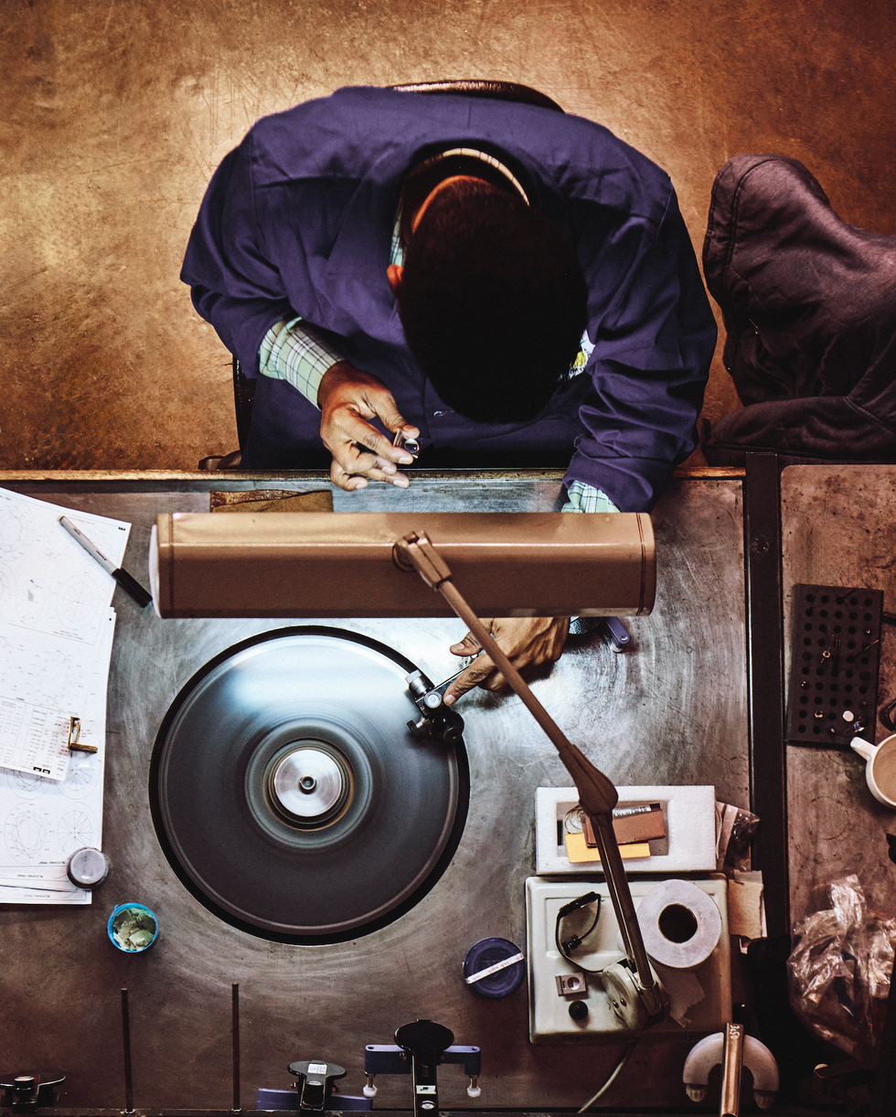 worker operating a machine in a workshop setting