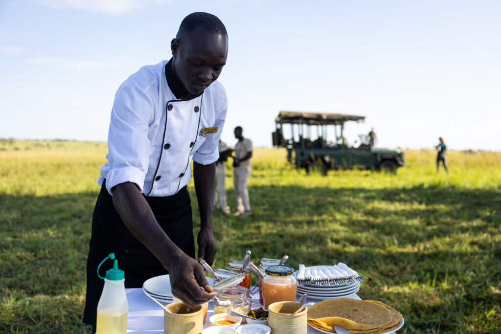 Chef preparing a bush breakfast, Uganda, WildPlaces