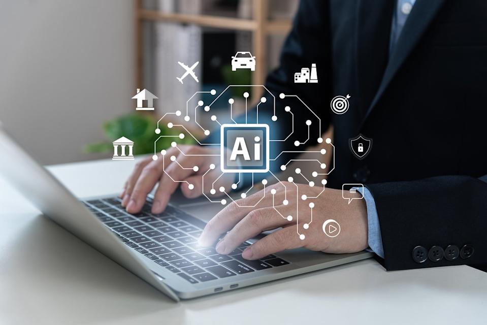 Worker using AI on a laptop.