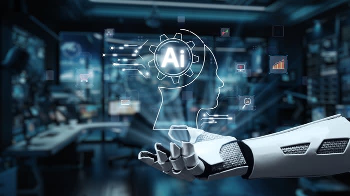 A rendering of a robot hand projecting a hologram of Ai.