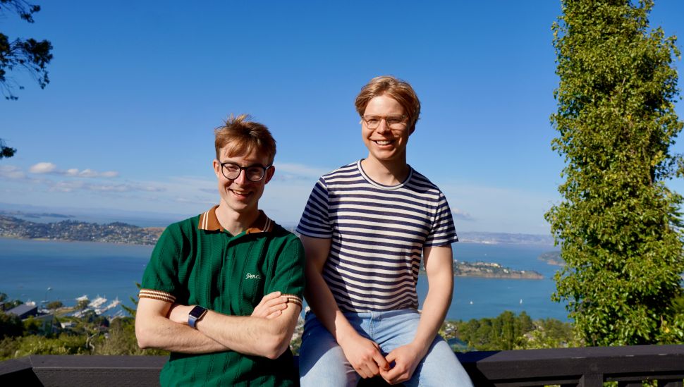 Two young men in casual t shirts posing for a photo