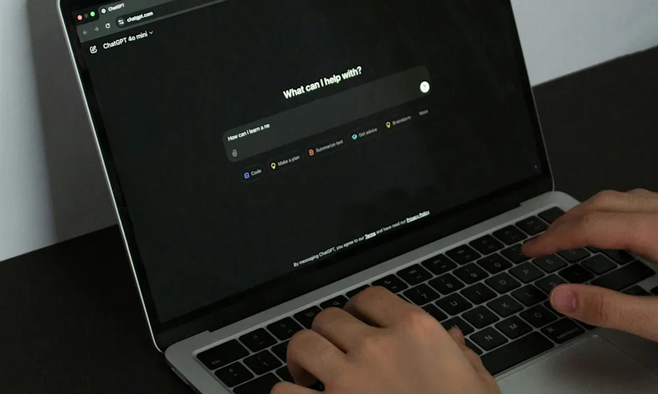 Person using ChatGPT on a MacBook.
