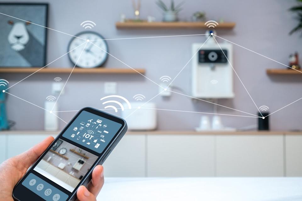 A person using their phone to control appliances in their smart home.