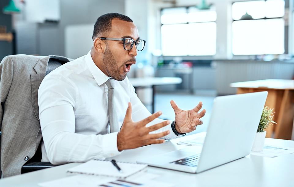 An investor looking at a laptop screen is happily shocked.