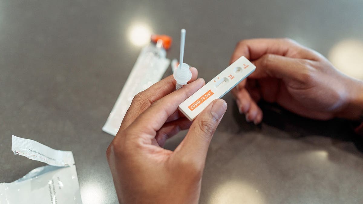 A man looks at a COVID-19 test.