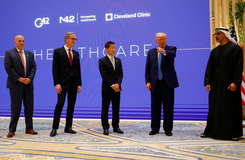US President Donald Trump speaks next to Crown Prince of Abu Dhabi Sheikh Khaled bin Mohamed bin Zayed Al Nahyan, CEO of Cleveland Clinic Tom Mihaljevic and CEO of G42 Peng Xiao as he attends a business forum at Qasr Al Watan during the final stop of his Gulf visit, in Abu Dhabi, UAE.
