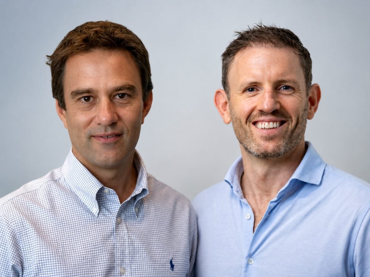 Side-by-side featured image showing Dimitris Vassos, CEO and cofounder of Omilia, left, and Oliver Thomas, founder and managing partner of Expedition Growth Capital. Both are pictured in professional business attire against a neutral, softly blurred background, facing the camera in a polished corporate portrait.