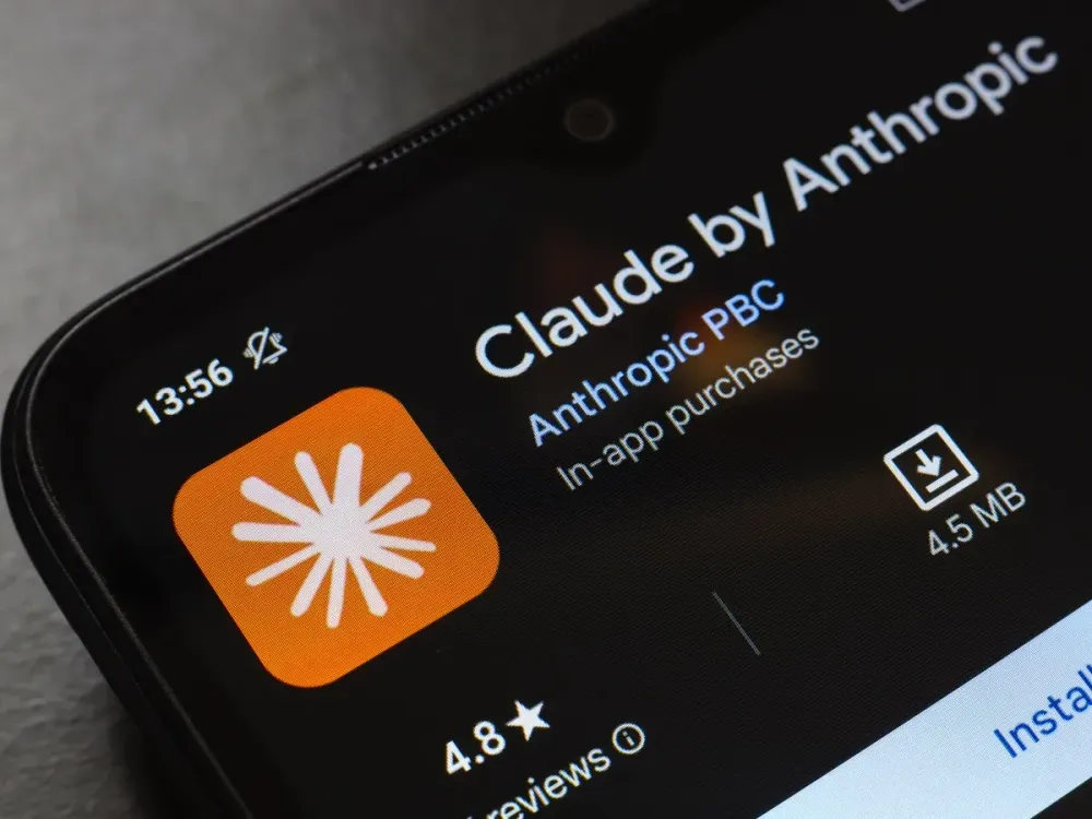 The Claude by Anthropic app logo appears on the screen of a smartphone